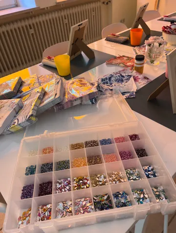 Colorful beads in box on craft table.