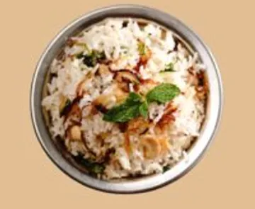 Rice garnished with herbs in a bowl.