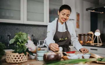 Chef preparing food in modern kitchen.
