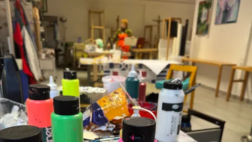 Paint bottles on table in art studio.