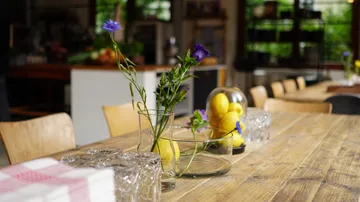 Flowers in vase on restaurant table.