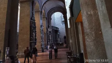 People walking inside a large cathedral.