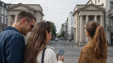 Three people looking down city street.