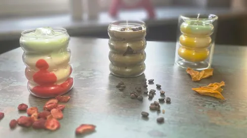 Layered candles on a table with decor.