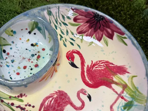 Decorative plate with flamingos and flowers design.