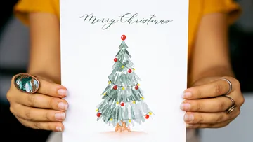Hands holding a Christmas card.