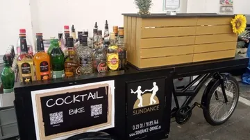Cocktail bike displaying assorted liquor bottles.