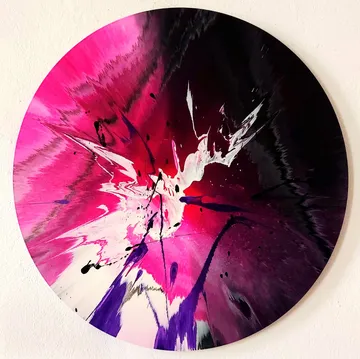 Abstract circular art with paint splashes.