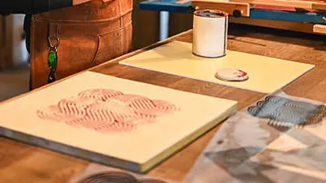 Wood surface with art supplies, patterned paper.