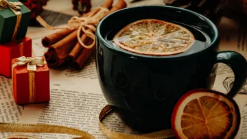 Mug with orange slice on festive table.