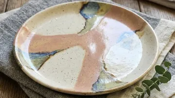 Keramikteller mit abstraktem Design auf Tisch.