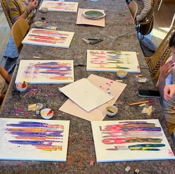 Bunte Gemälde auf Tisch im Kunstkurs.