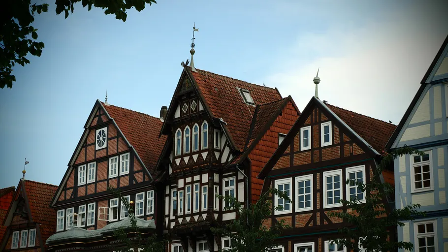 Timber-framed houses under a clear sky.