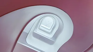Spiral staircase seen from below, modern architecture.