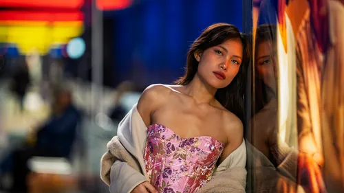 Woman posing against a reflective wall.