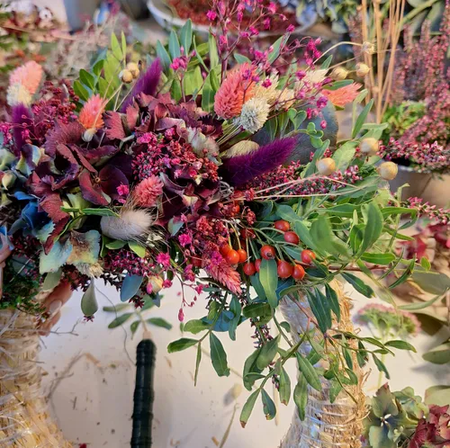 Colorful floral arrangement on straw base indoors.
