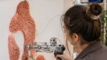 Artist using painting tool on canvas