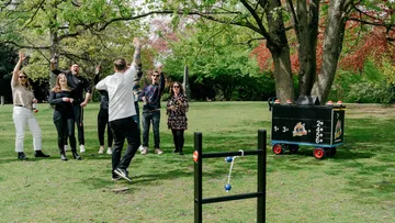 Group playing outdoor ladder toss game.