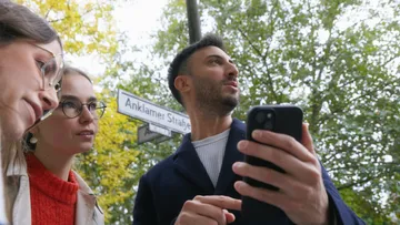 People looking at phone outdoors