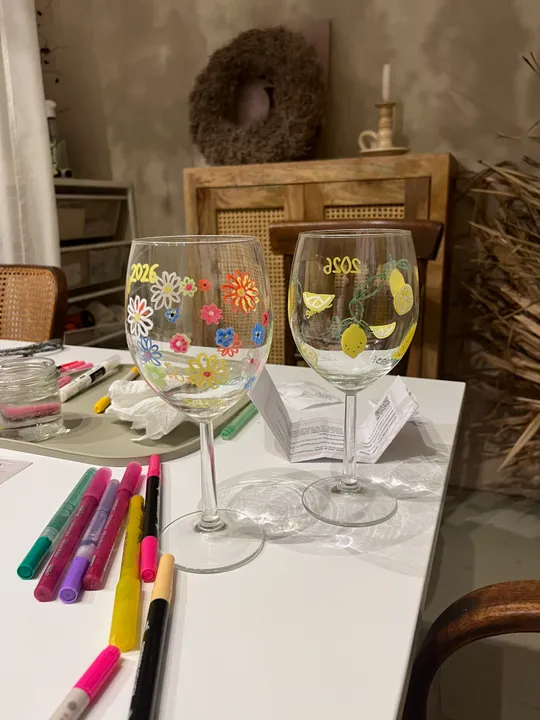 Decorated wine glasses on a table.