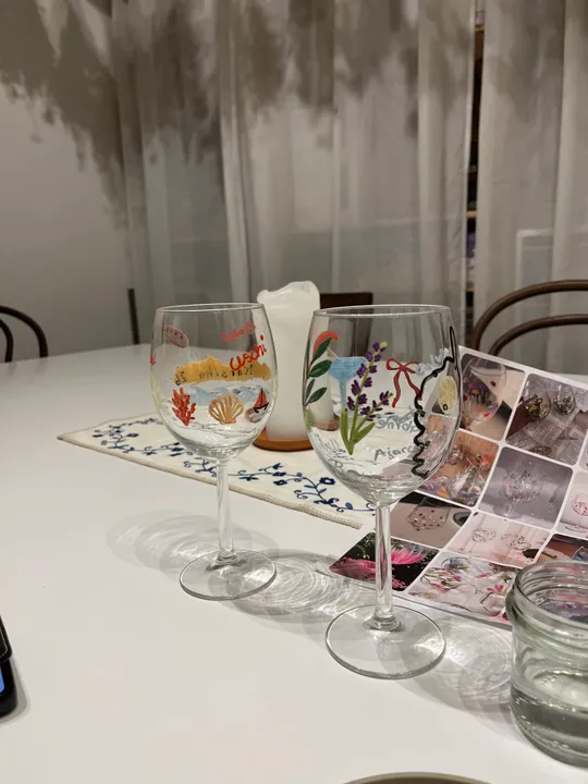 Painted wine glasses on a white table.