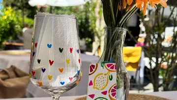 A decorated glass and vase outdoors.