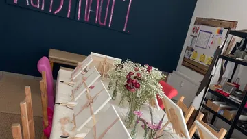 Art studio with canvases on table.