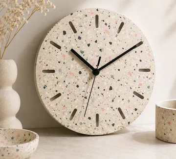 Round terrazzo clock on a tabletop.