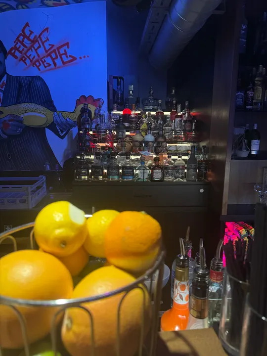 Bar with drinks and fruit basket.