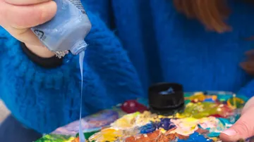 Paint squeezed onto an artist's palette.