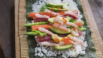 Sushi ingredients on a bamboo sushi mat.