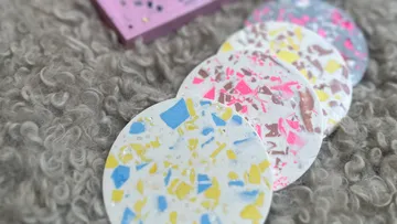 Terrazzo coasters on a textured surface.
