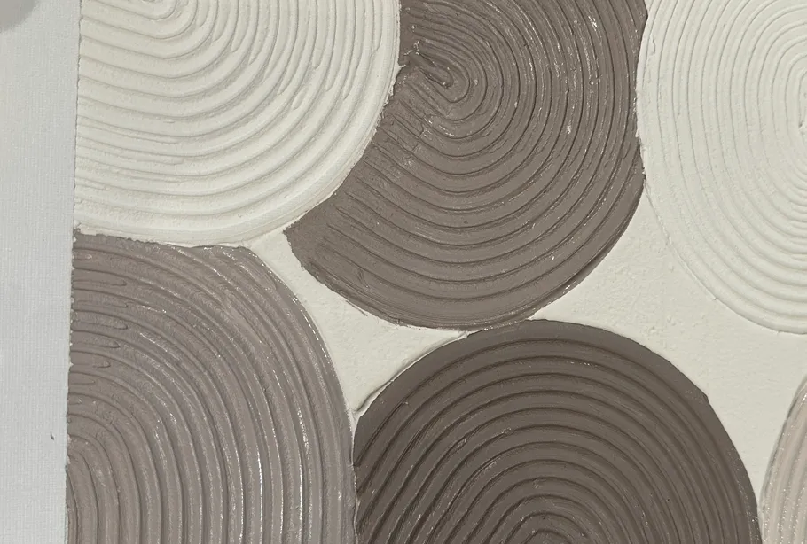 Textured circles with spiral patterns overlap.