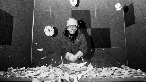 Person breaking plates in padded room.