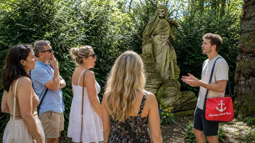 Führer erklärt Gruppe Statue im Garten.