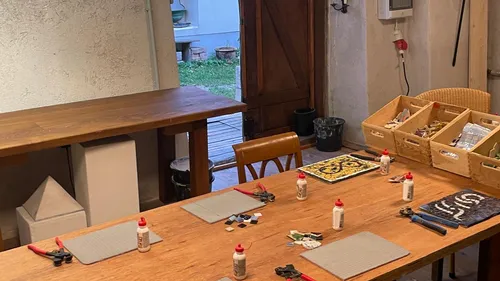 Table with art supplies in cozy room.