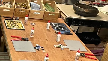 Crafting materials arranged on workshop table.