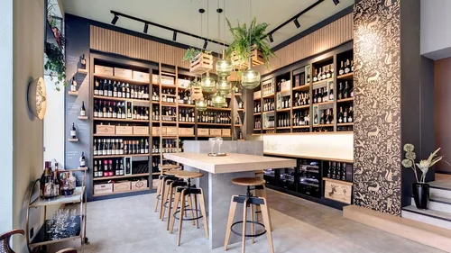 Wine bottles arranged in modern cozy wine bar.
