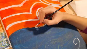 Hand painting on vibrant, abstract canvas.