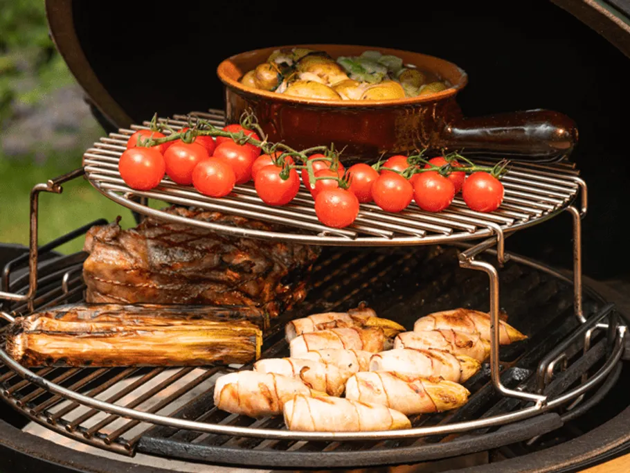 Grill with grilled meat, vegetables and tomatoes in the garden.