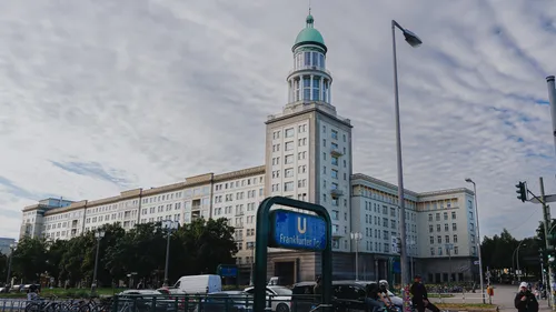 Large building with tower, urban setting.