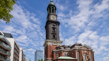 Historic clock tower in urban setting.