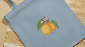 Blue tote bag with lemon embroidery.