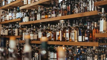 Whiskyflaschen auf Holzregalen.