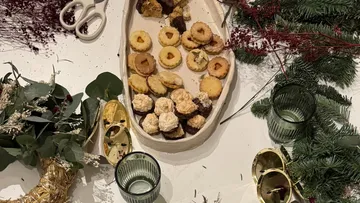 Cookies on platter, surrounded by greenery.