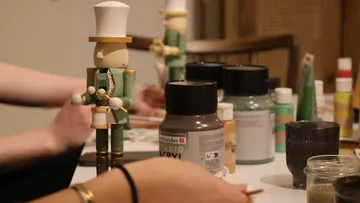 Wooden figures painted on a table.