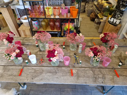 Flower bouquets arranged on wooden table.