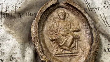 Medieval seal on old manuscript surface.