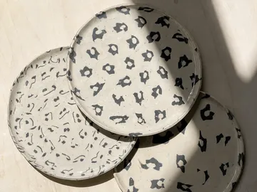 Three patterned plates on a light surface.