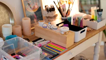 Art supplies on a wooden table.